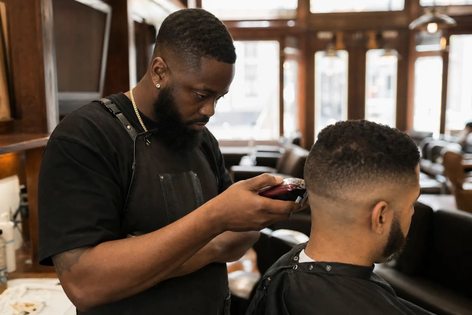 Class A barber giving a client a fade with clippers in a Texas barbershop