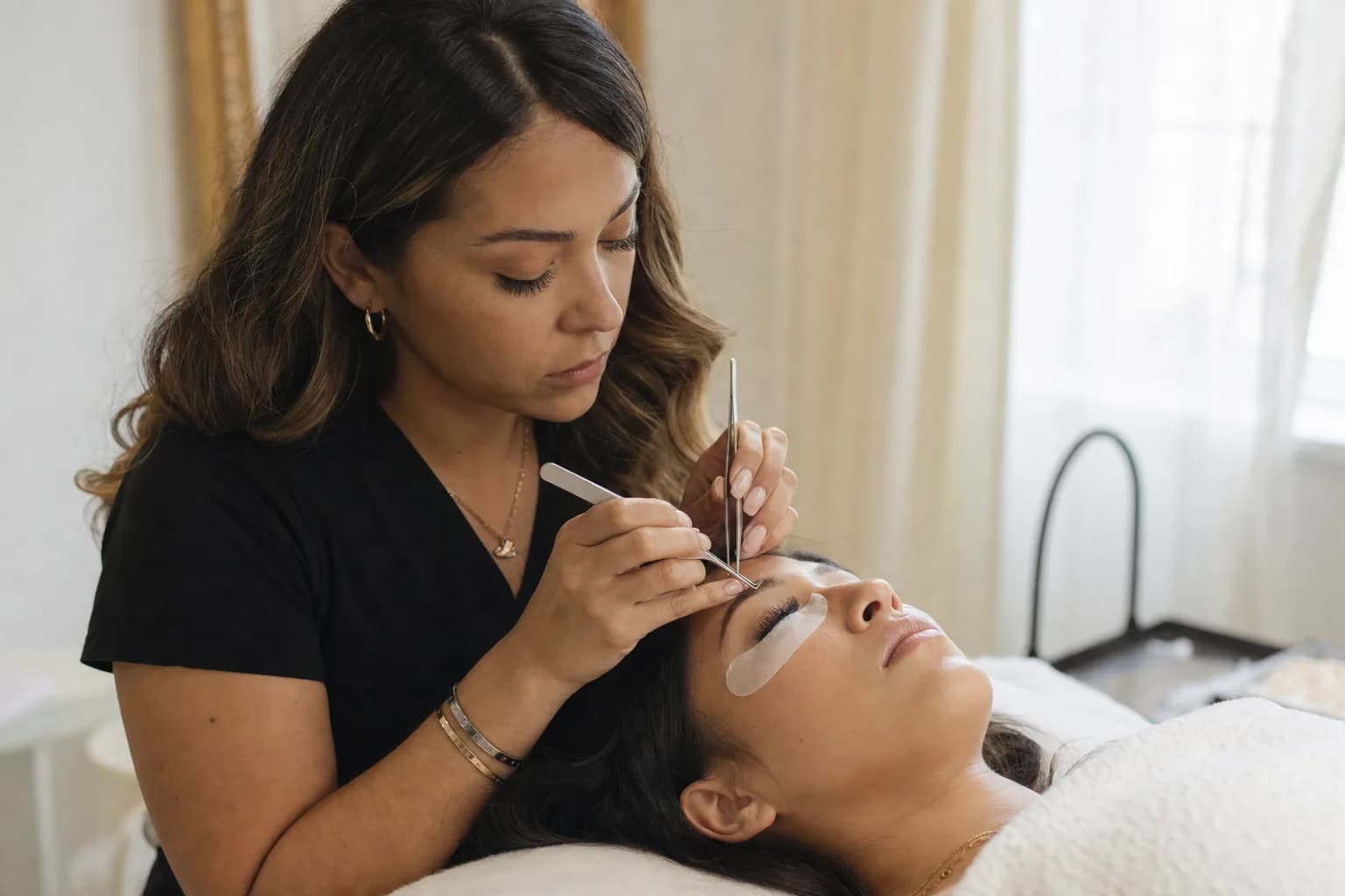 Lash artist applying individual eyelash extensions in a Texas lash studio